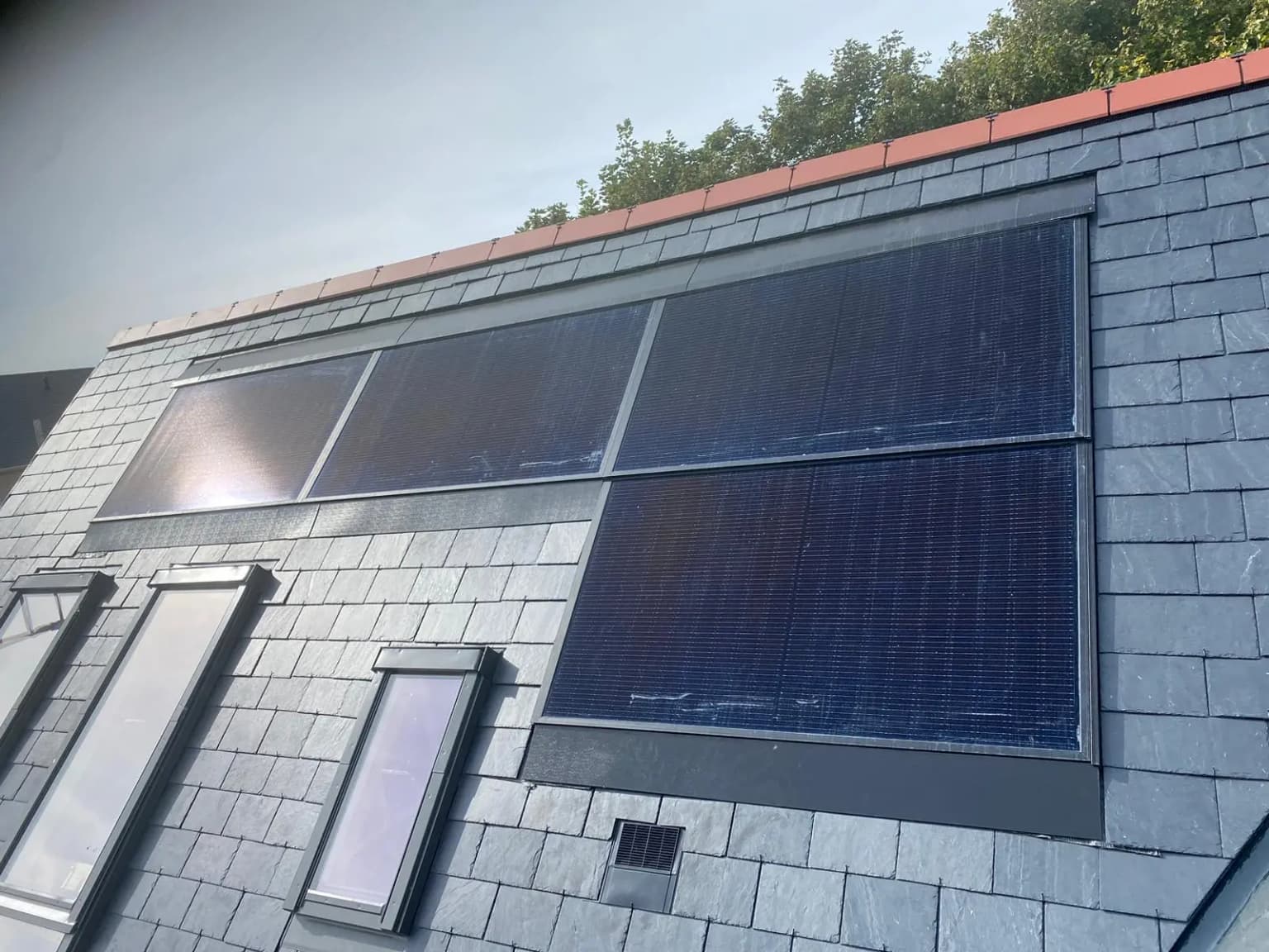 Solar panels integrated into roof wall section