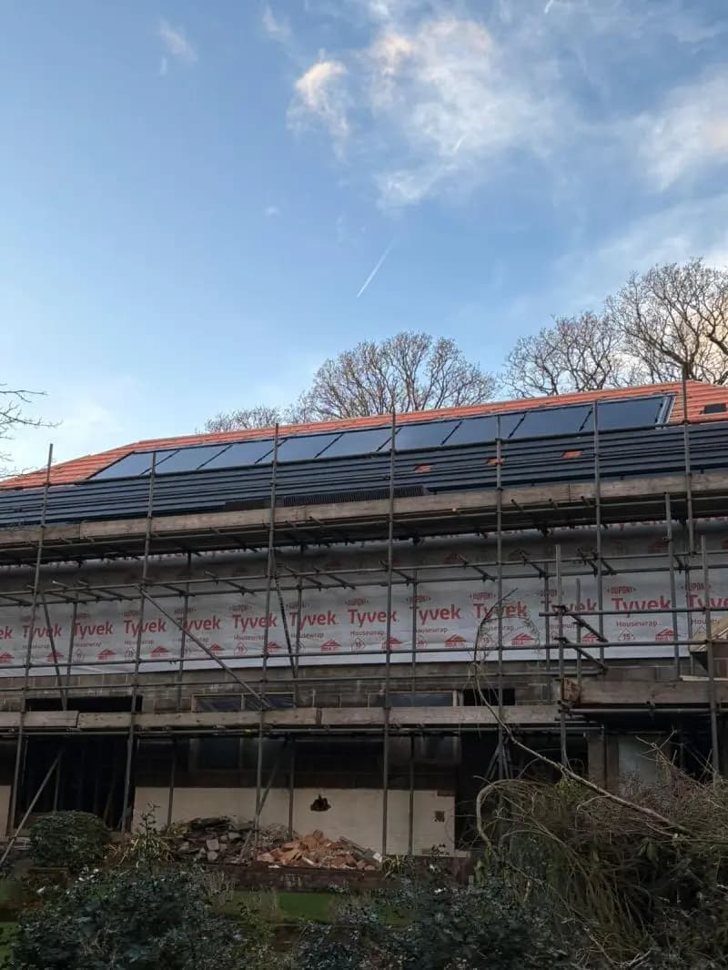 House with scaffolding and solar panel installation